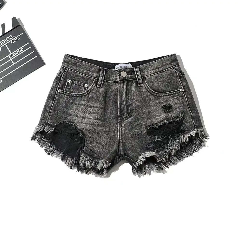 A stylish pair of women's low waist denim shorts with fringe detailing and distressed accents