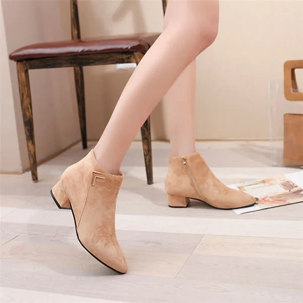 Elegant pointed toe ankle boots featuring a chunky heel and side zipper detail for stylish comfort