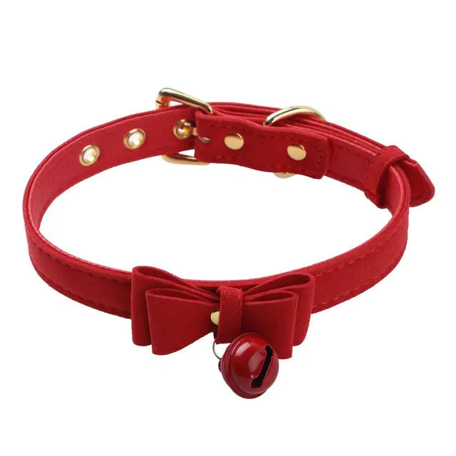 A stylish black choker collar necklace featuring a small gold bell pendant for a fashionable and edgy accessory look