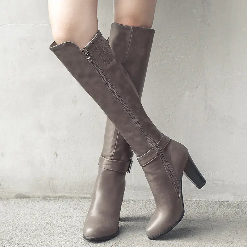 Knee-high chunky heel Martin boots featuring a stylish side zipper for easy wear and a bold, modern look