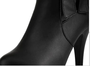 Playful pink artificial PU boots with a cozy velvet lining, bow embellishment, and durable sole