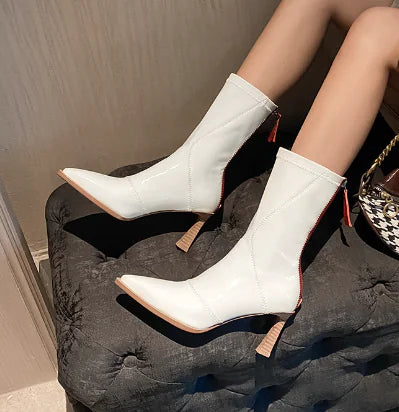 Elegant imported women's leather ankle boots featuring a stylish zipper closure and sleek design for versatile fashion statements