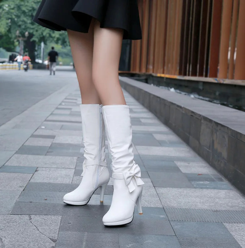 Bright pink artificial PU boots with a stylish bow, velvet lining, and high heel for versatile wear