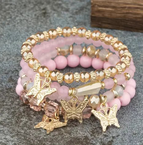 A close-up of colorful beaded bracelets featuring butterfly-shaped charms and intricate designs, showcasing vibrant hues and handcrafted details for Butterfly Bliss Beaded Bracelets