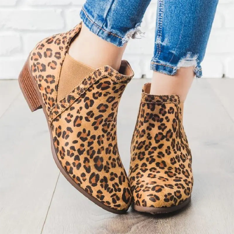 A stylish pair of leopard print chunky heel round toe Martin boots showcasing bold animal print and sturdy footwear design