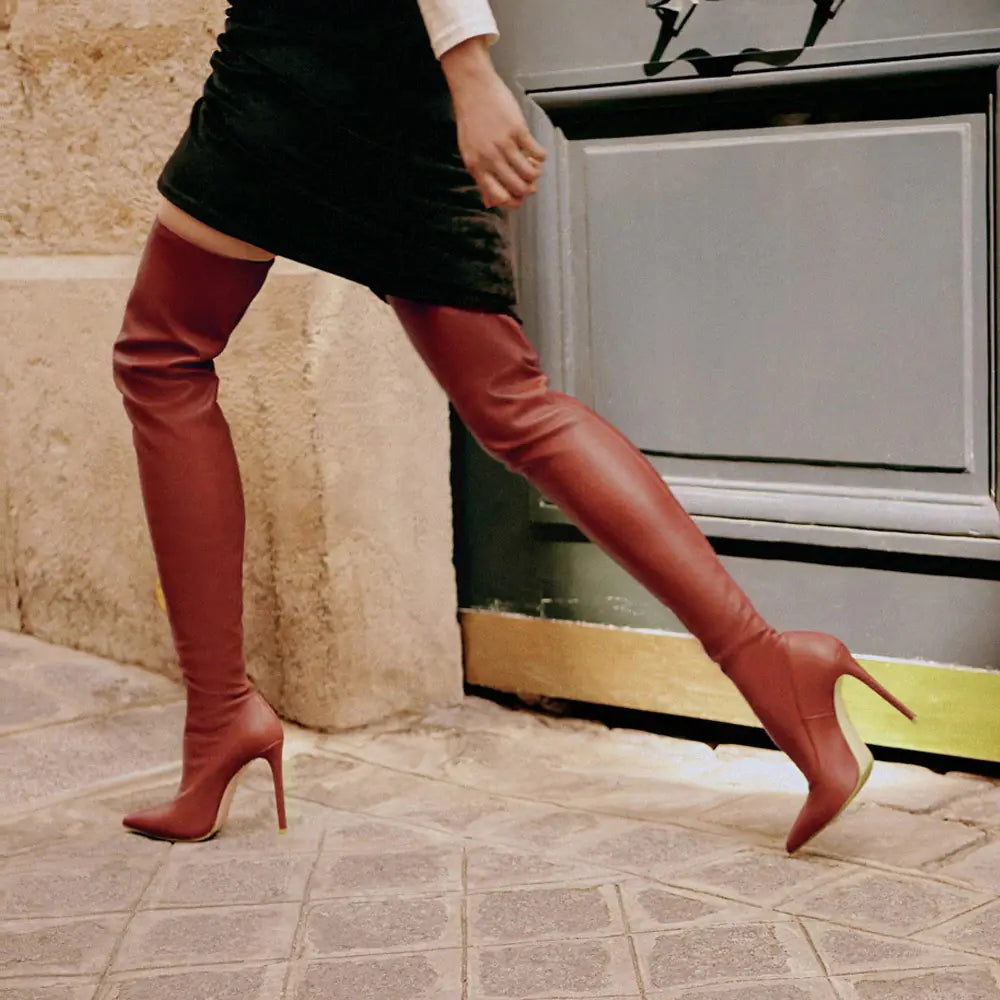 Fashionable brown over-the-knee boots with super high stiletto heels and sleek silhouette