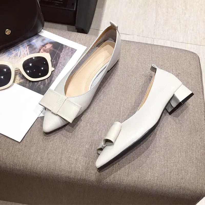 Front view of apricot Mary Jane shoes emphasizing the charming bow accessory and pointed toe