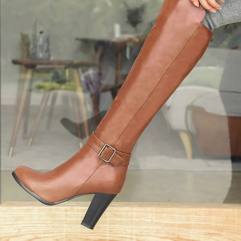 A stylish pair of knee-high chunky heel Martin boots featuring a side zipper for easy wear and a trendy, bold fashion statement