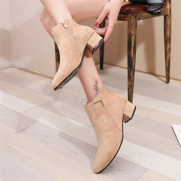 Stylish pointed toe chunky heel ankle boots featuring a side zipper for easy wear and a sleek modern look
