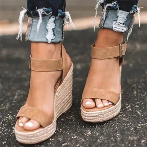 Elegant fish mouth sandals featuring a stylish wedge sole and adjustable belt buckle for a chic summer look
