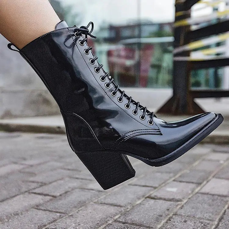 Elegant women's Martin boots featuring a pointed toe, high heel, and sleek leather ankle design