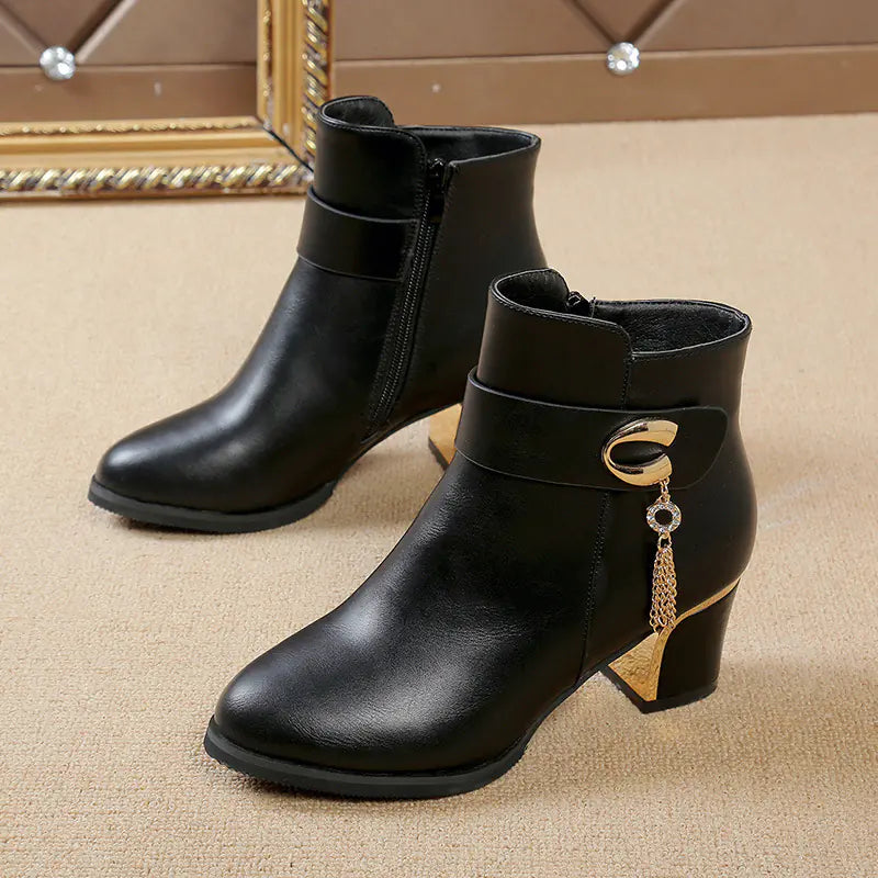 A stylish pair of women's round toe high heel chunky ankle boots in black leather, perfect for fashion-forward outfits and everyday wear