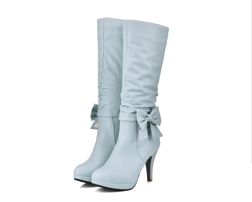 Vibrant white artificial PU boots with a large bow knot, comfort lining, and sturdy heel