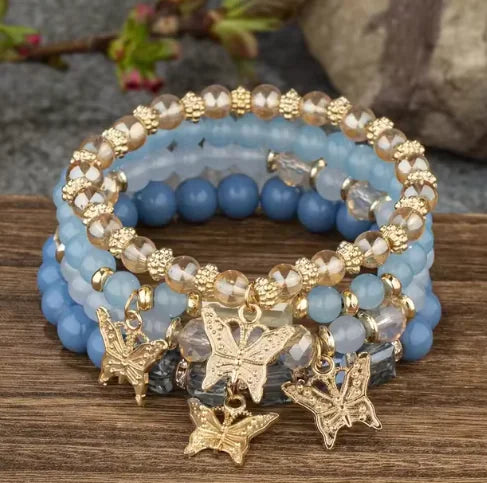 A close-up of Butterfly Bliss Beaded Bracelets featuring colorful beads and delicate butterfly charms, perfect for stylish, feminine wrist accessories