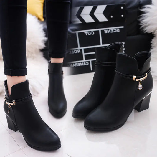 A stylish pair of women's chunky heel Martin boots featuring a round toe design, black leather finish, and sturdy platform soles perfect for casual or edgy fashion statements
