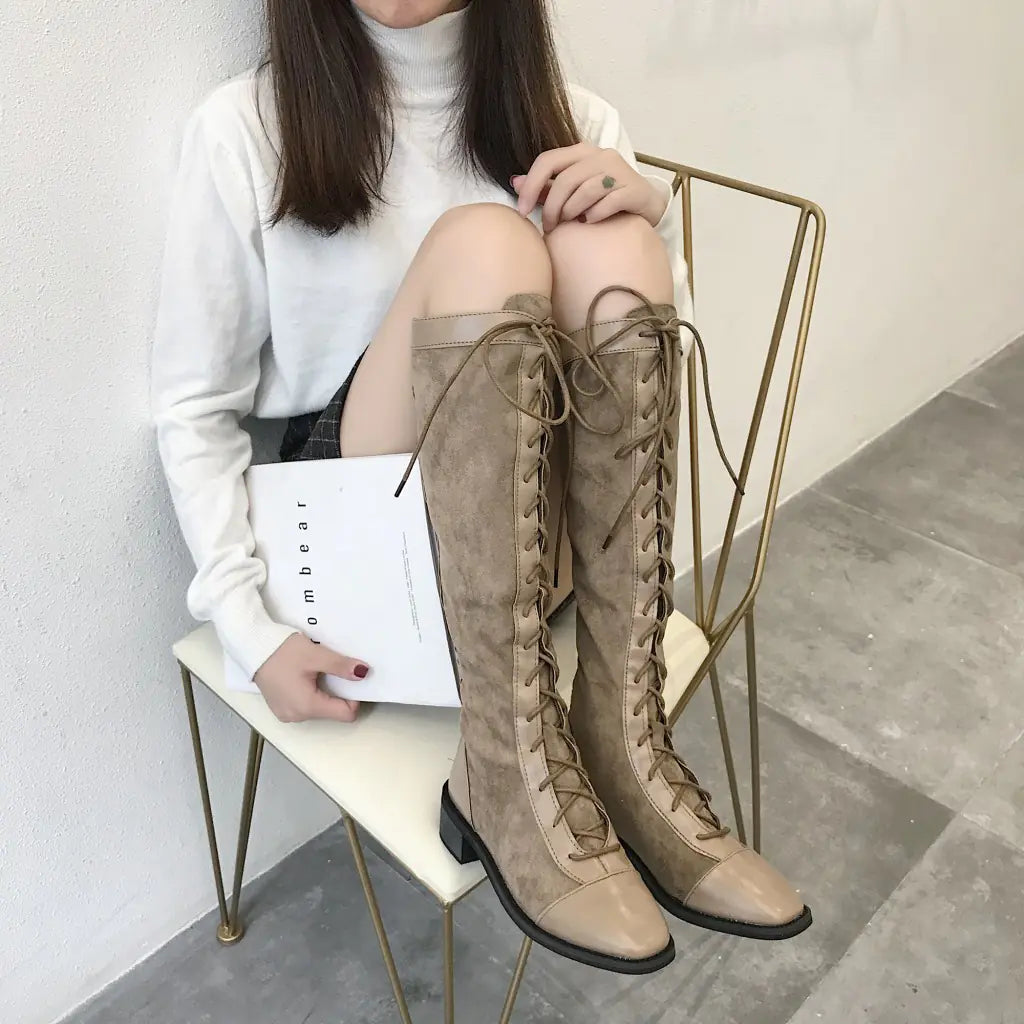 A stylish pair of chunky heel knee-high boots featuring a sleek design with a comfortable thick heel, perfect for fall and winter fashion