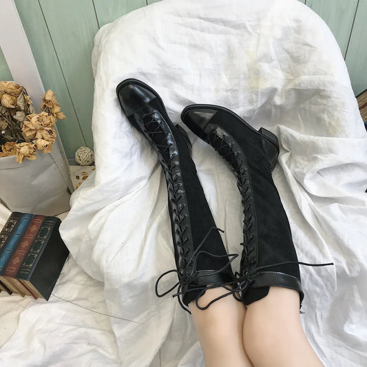 Stylish chunky heel knee-high boots in black leather with a rugged sole and sleek design for fashionable winter wear