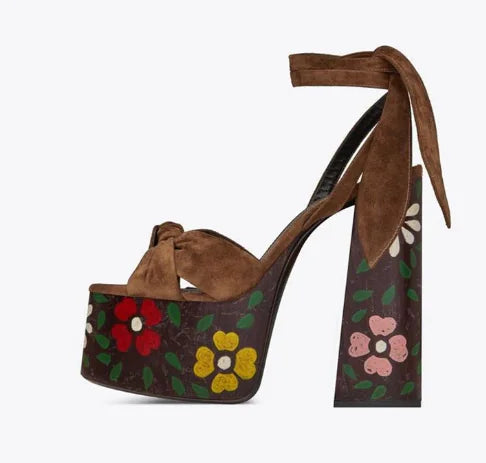 Pair of retro platform peep-toe heels featuring color block design, crossing straps, bow and heart embellishments, in various vibrant colors with rubber sole and plush sheepskin lining