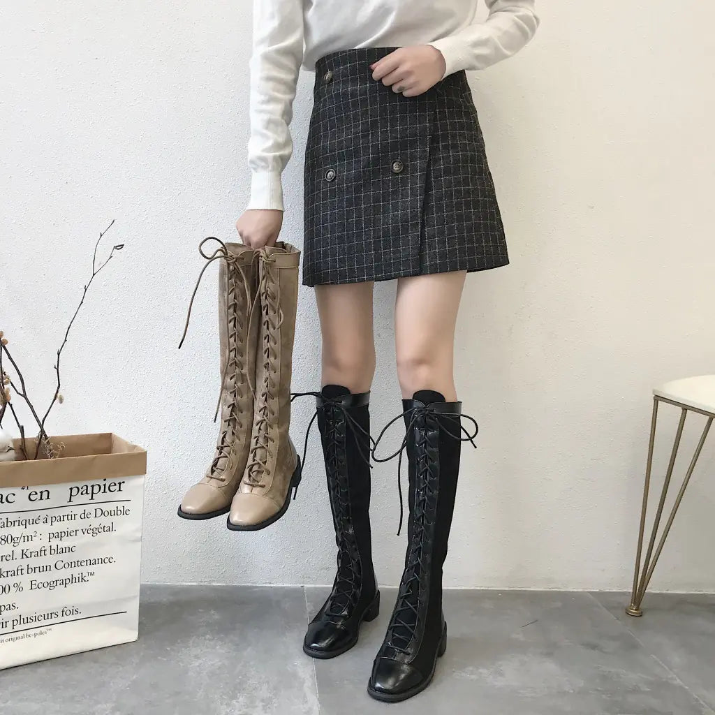 Elegant chunky heel knee-high boots featuring a stylish design, sturdy soles, and versatile fashion appeal for modern outfits