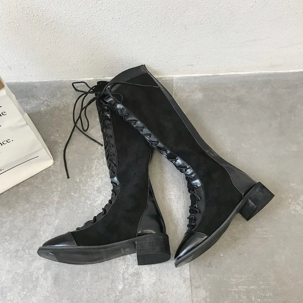 A stylish pair of chunky heel knee-high boots featuring a sleek design, sturdy heels, and comfortable fit suitable for fashionable winter or fall outfits